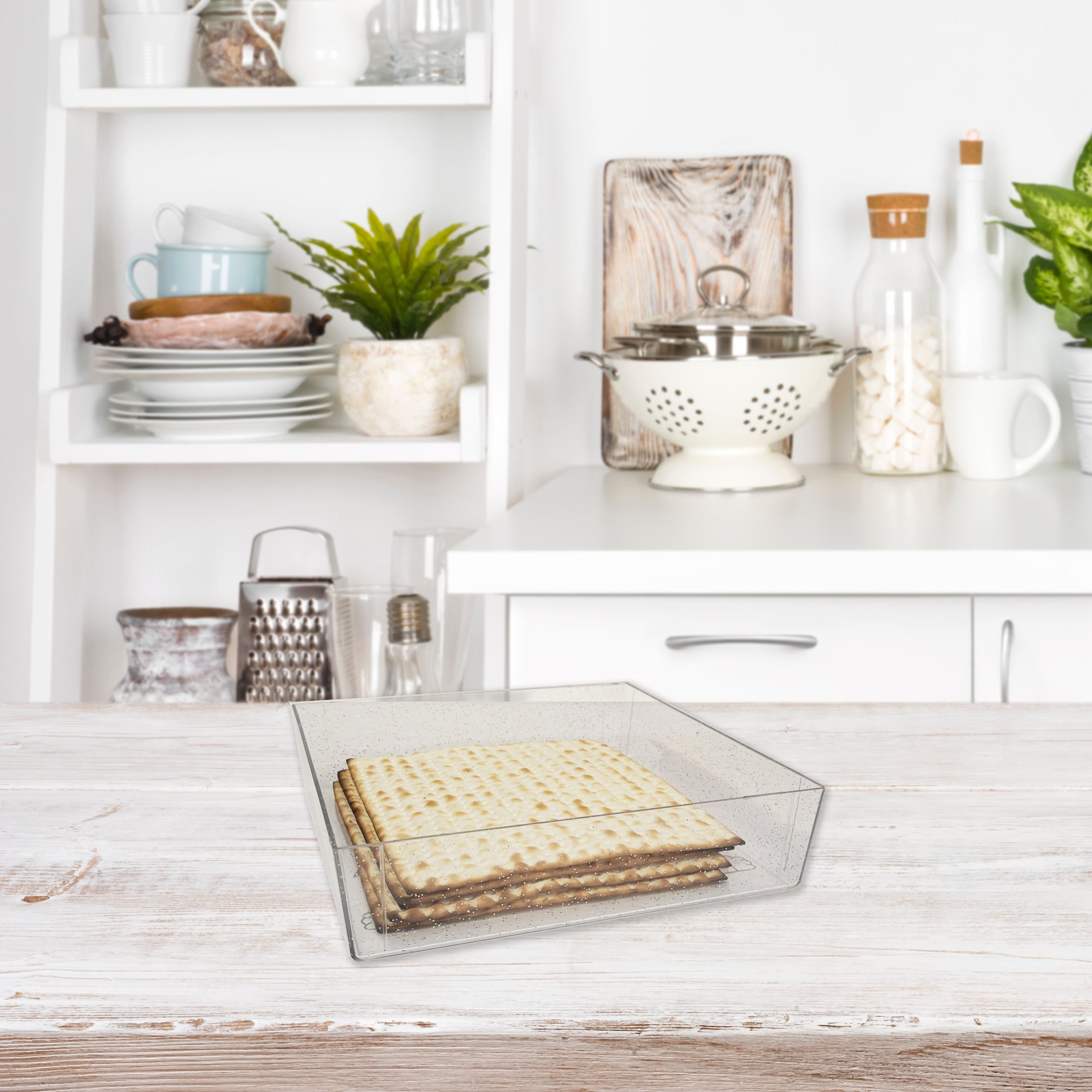 Wooden table over blurred image of kitchen bench and shelf